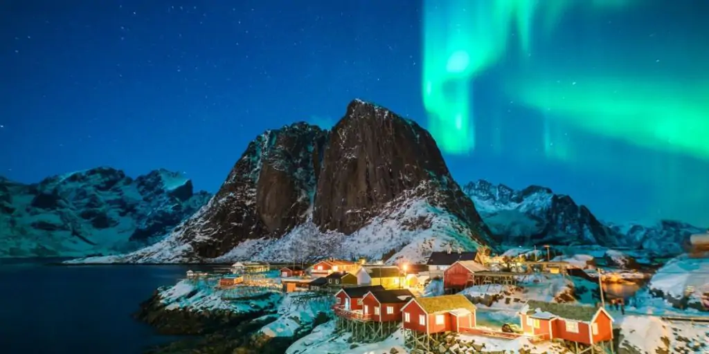 northern lights above houses