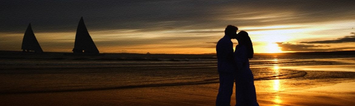 Kissing on the beach at sunset