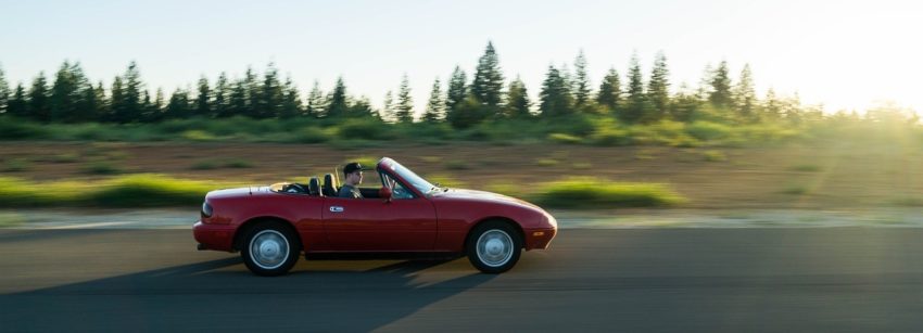 Red sports car on a road trip