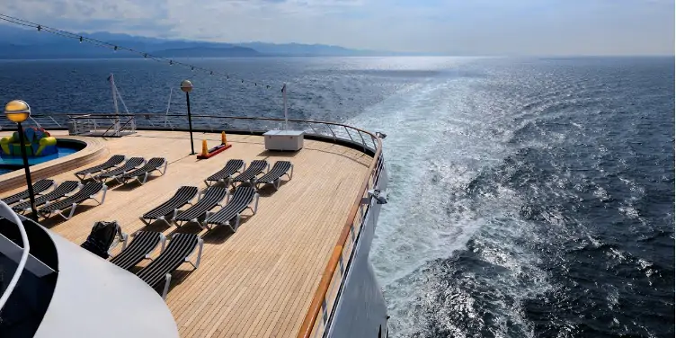 an image of the stern of a cruise ship with rows of sun loungers