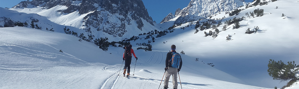 Image of couple skiing in mountains
