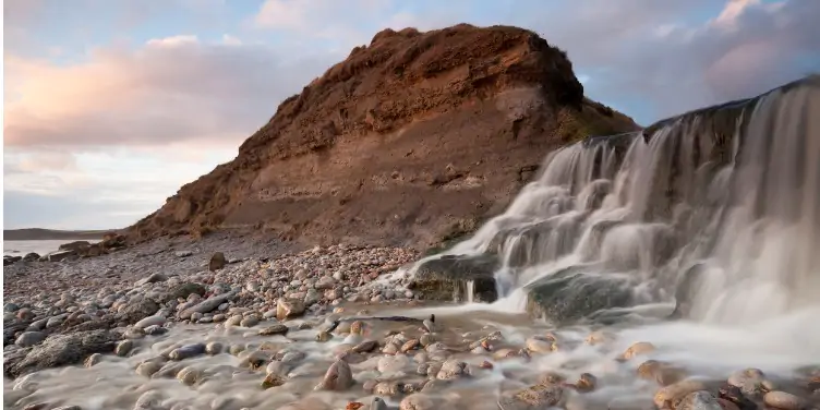 an image of the waterfall at the beach on the Jurassic Coast walk near Osmington Mills, Dorset