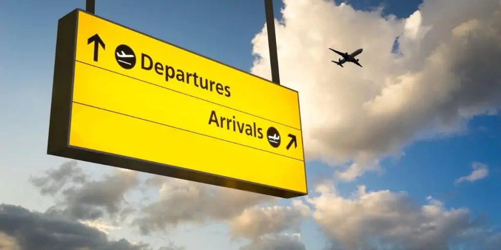 departures sign with sky backdrop