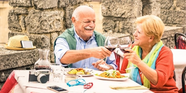 senior couple enjoying food on holiday