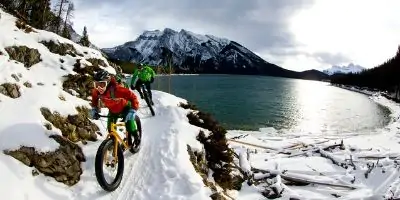 couple on bikes in the snow