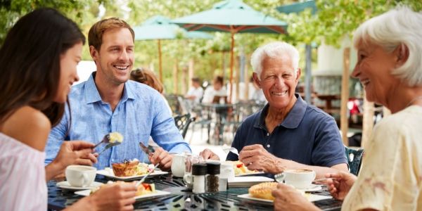 senior parents and their children eating on holiday