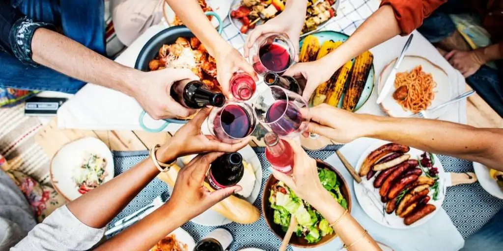 people toasting together over dinner