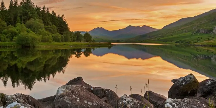 Sunset over a lake in Snowdonia National Park in Wales