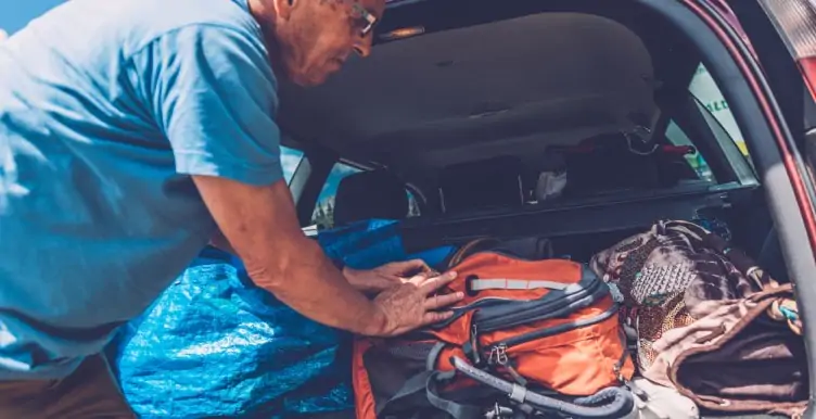 Senior man packing car