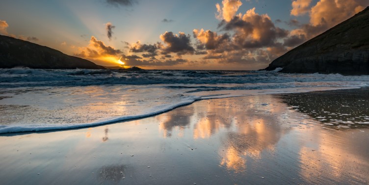 Sunset reflection on a beach in Mwnt