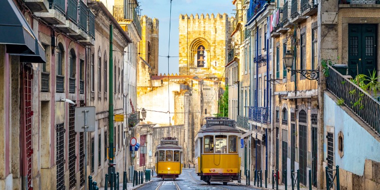 an image of two trams transporting people up and down the hilly streets of Lisbon
