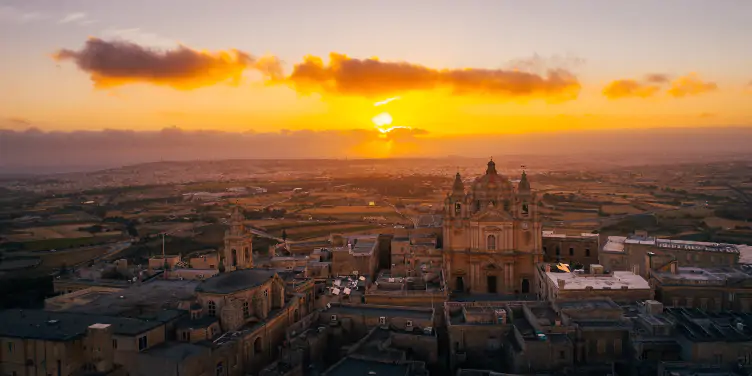 an image of the city of Mdina at sunset
