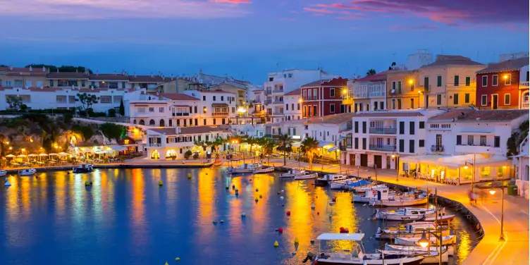 an image of Cales Fonts port, in Mahon, Menorca, at sunset