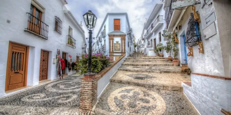 Narrow, mosaic paved streets in the whitewashed village of Frigiliana