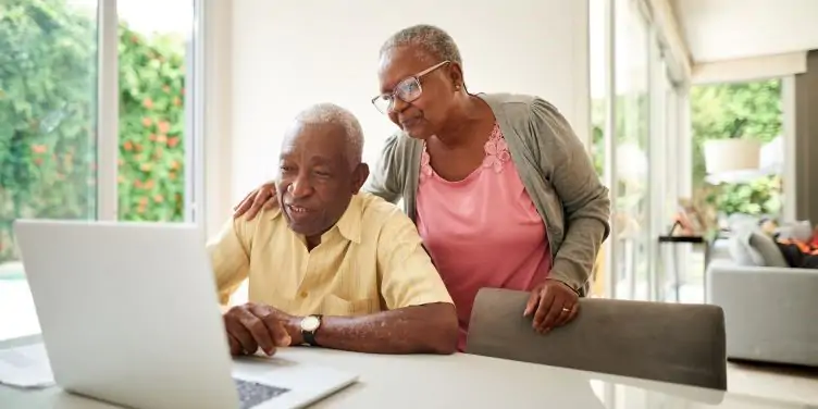 Mature couple at home using a laptop