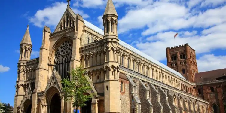 St Albans Cathedral in St Albans, England with a blue sky and some clouds.