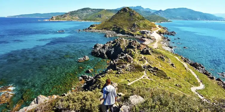 Girl walks down from Genoese Tower of Parata peninsula