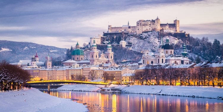 Nighttime view of Salzburg and the Salzach river in winter