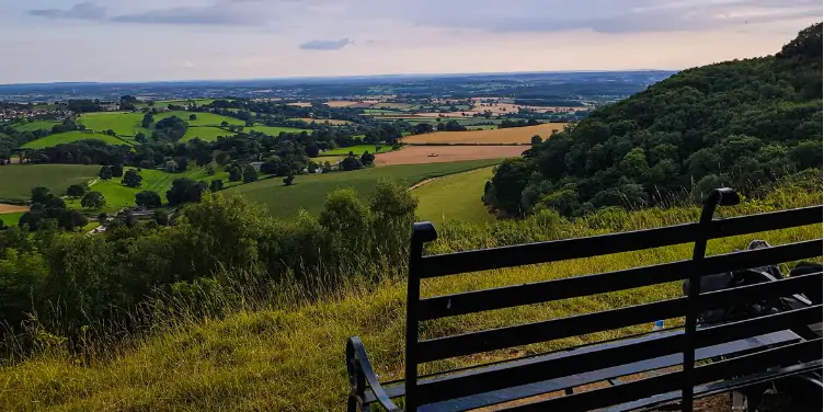 An image of a bench with a view on the Cotswold Way