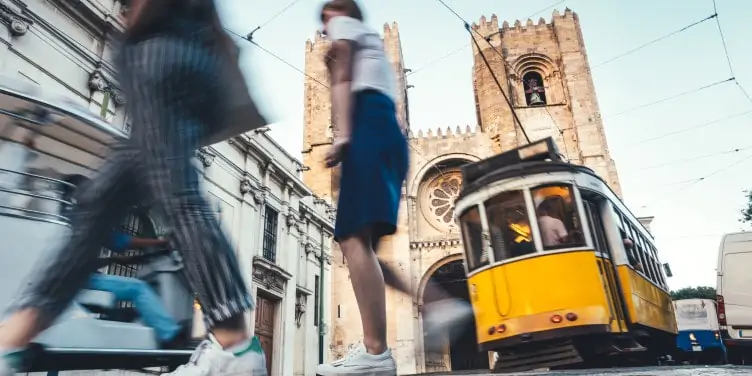 Tram in central Lisbon with a cathedral in the background