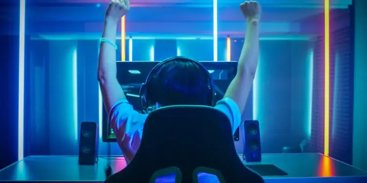 Young adult celebrating on a video game