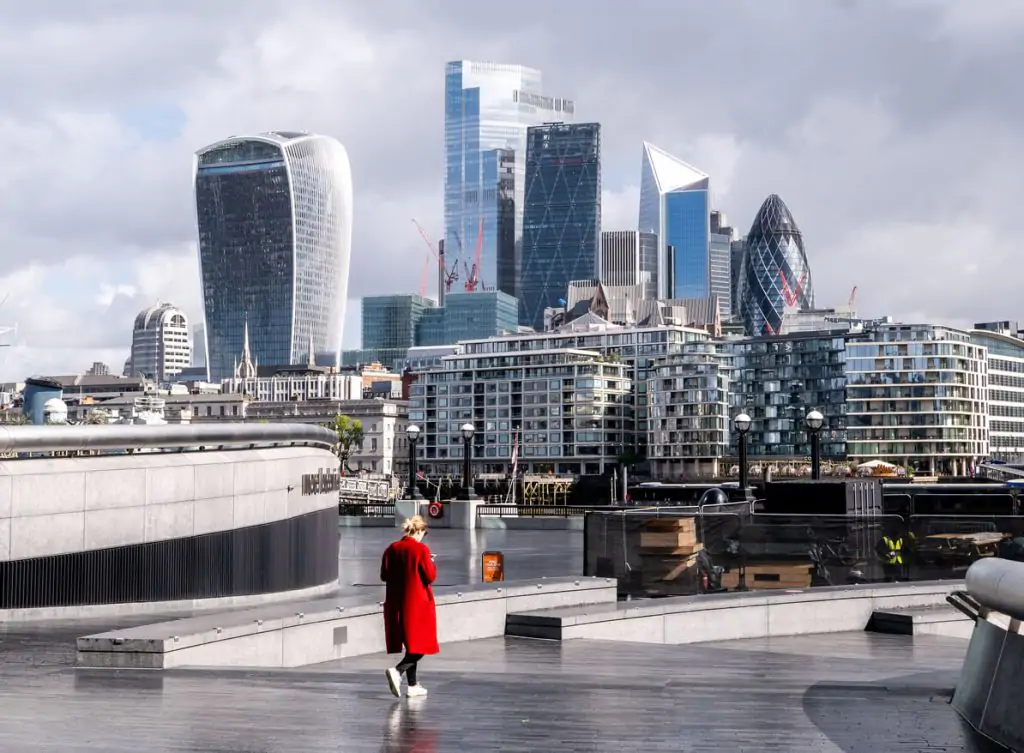 London cityscape with woman wearing red coat