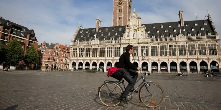Cyclist in front of the Old Library in bike friendly Leuven, Belgium