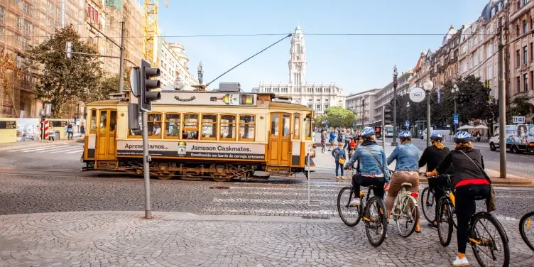 Cyclists wait to cross the road in European bike-friendly city of Porto