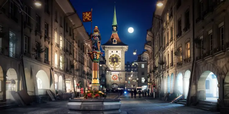 Alt an image of the famous Zytglogge clock in Bern, Switzerland at night