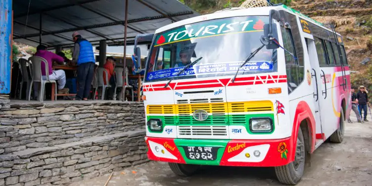 an image of a tourist bus in the mountains of Nepal