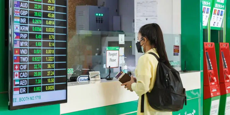 an image of a tourist exchanging currency in an airport