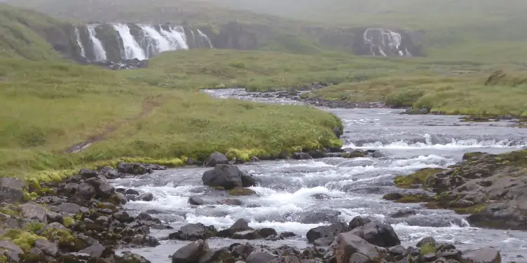 an image of a stream on a foggy day in Seydisfjordur, Iceland