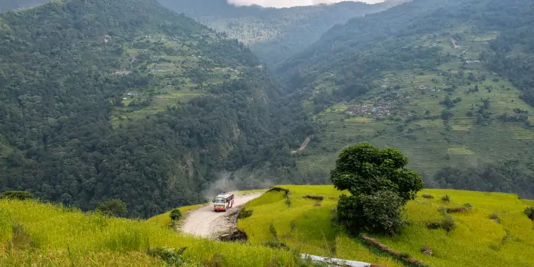 an image of a local bus driving in the mountains of Nepal