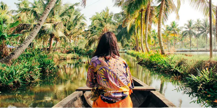 an image of a woman on a canoe in the forest