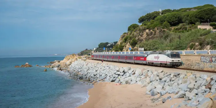 an image of a Renfe train on the Catalan coast in Spain