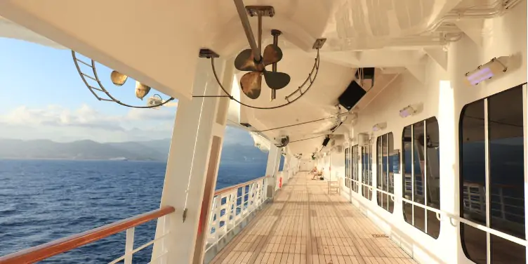 Cruise ship deck with hanging safety vessels and the sea on the left