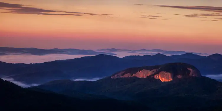 Looking Glass Rock in North Carolina reflecting the sun at dawn