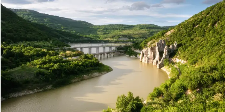 Tsonevo Reservoir in Bulgaria with the Chudnite Skali rock formation on its bank