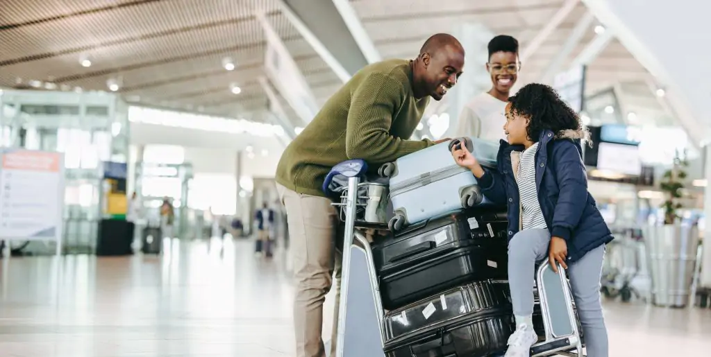 family with luggage at airport