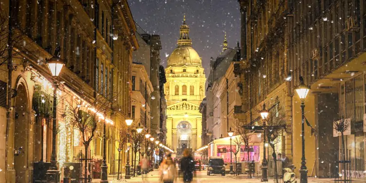 Zrinyi Street in Budapest, Hungary at night in winter with snow falling