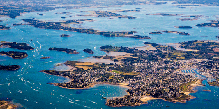Aerial view of the beautiful Golfe Du Morbihan, with the bright blue sea and small islands dotted throughout.