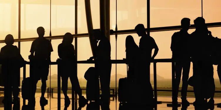 Silhouette of travellers waiting to board their flights.