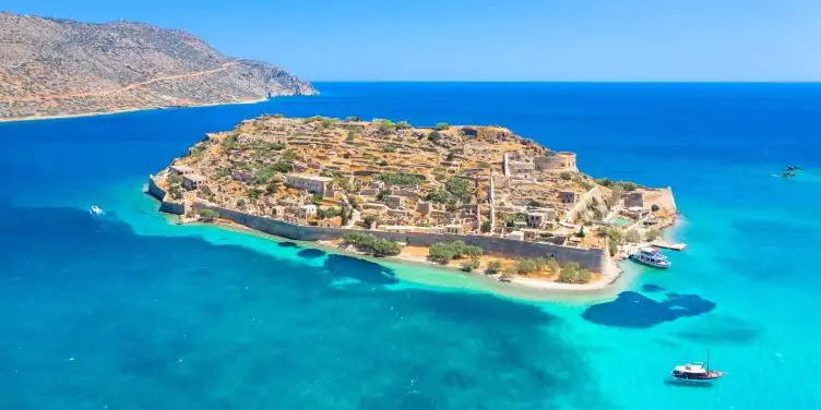 Skyview of the beautiful Island of Spinalonga, where the bright blue sea surrounds the island. 
