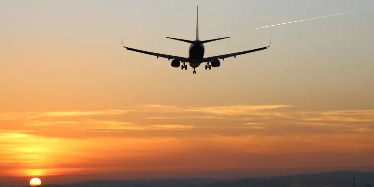 Aeroplane taking off at sunset