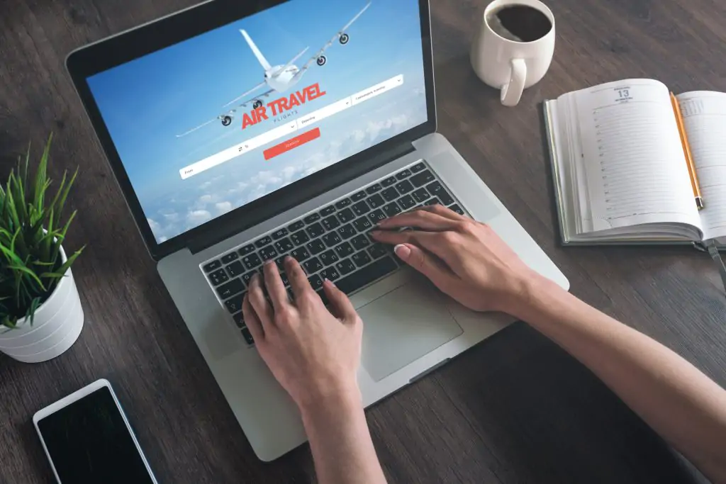 Woman looking for airline tickets on laptop