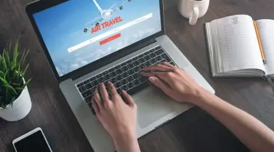 Woman looking for airline tickets on laptop