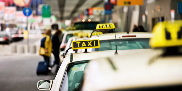 Long line of taxi’s line up outside of arrivals lounge at the airport