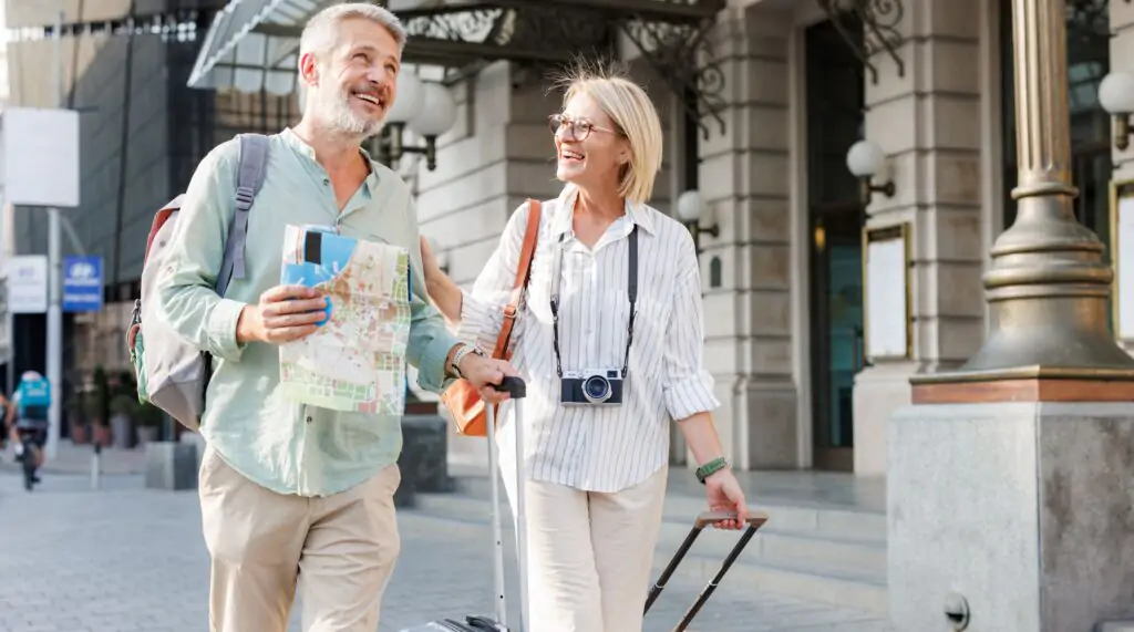 Senior couple walking with luggage