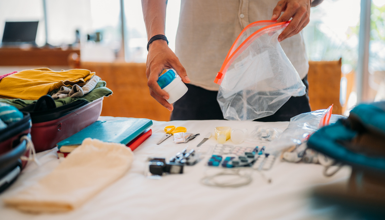 an image of an unrecognizable man packs tablets and vitamins in transparent plastic bags with a zipper.