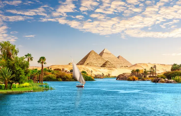 Beautiful Nile scenery with sailboat in the Nile on the way to pyramids, Aswan, Egypt.